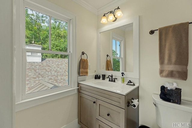 bathroom featuring ornamental molding, toilet, and vanity