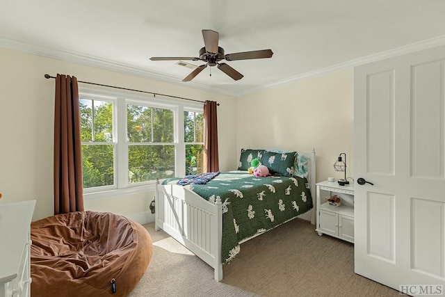 carpeted bedroom with ceiling fan and ornamental molding