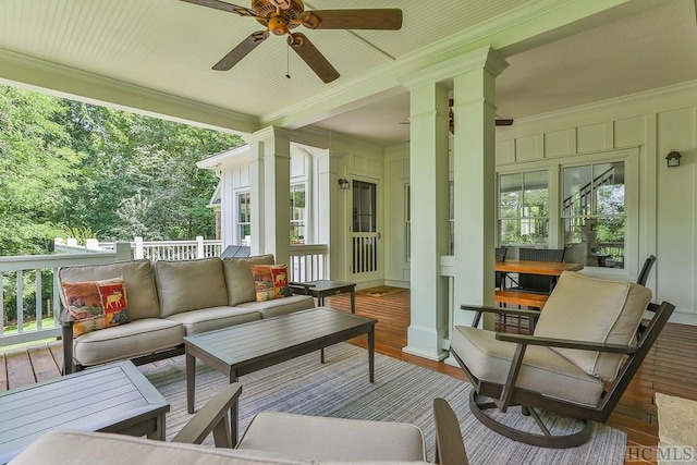 sunroom / solarium featuring ceiling fan