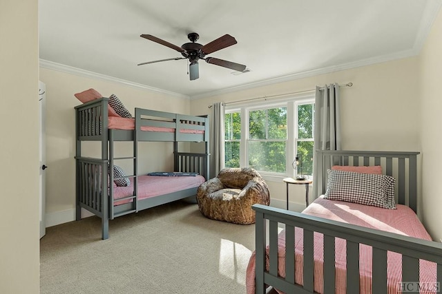 carpeted bedroom with crown molding and ceiling fan