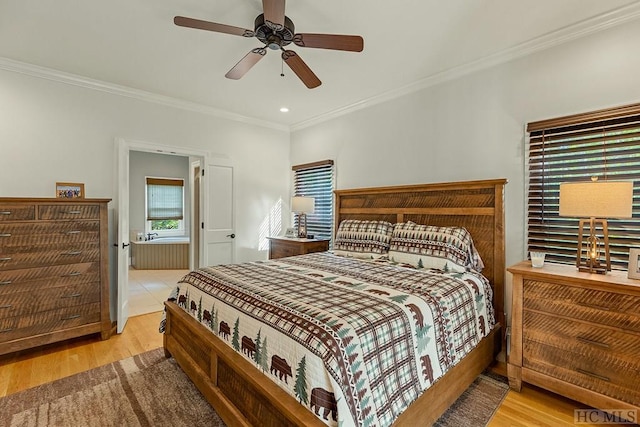 bedroom with ornamental molding, ceiling fan, and light wood-type flooring