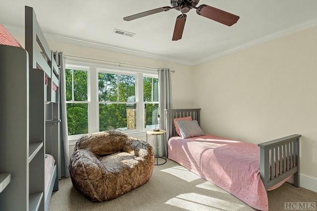 carpeted bedroom featuring crown molding and ceiling fan