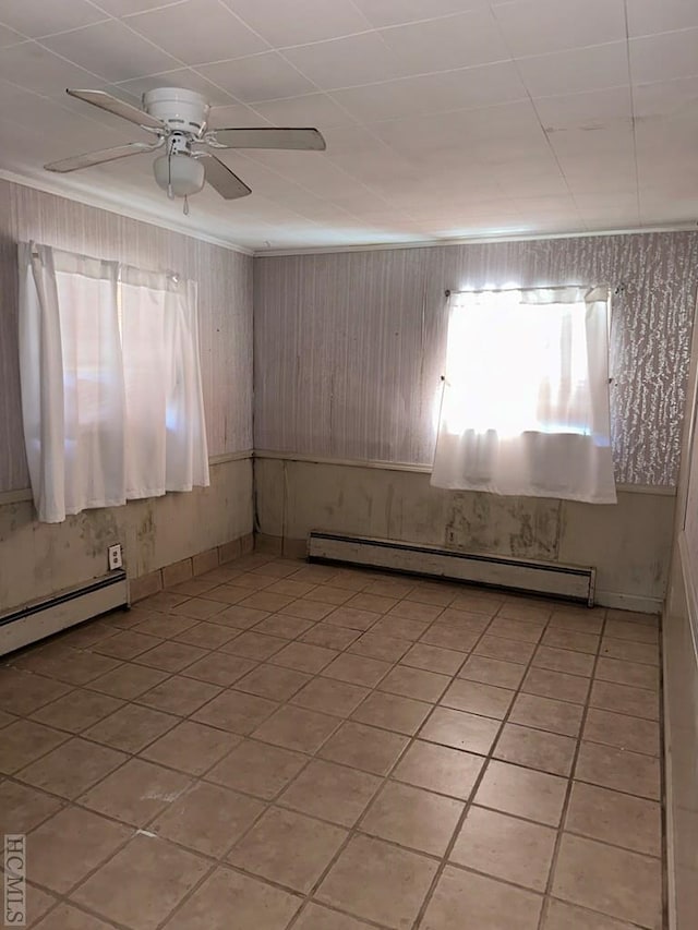 tiled empty room with a baseboard radiator and ceiling fan