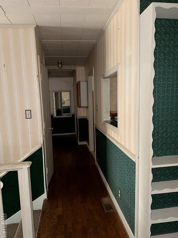 corridor with dark hardwood / wood-style flooring