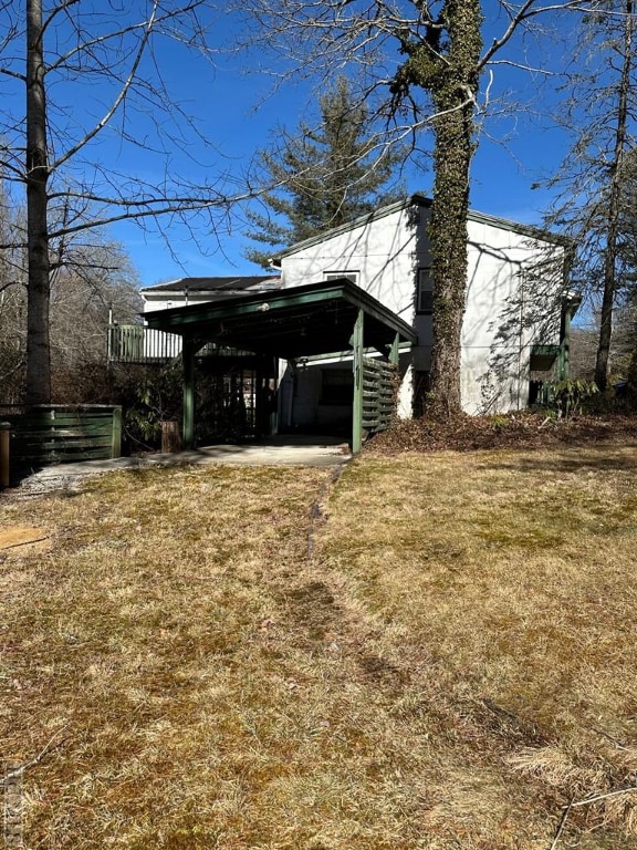 exterior space with a yard and a carport