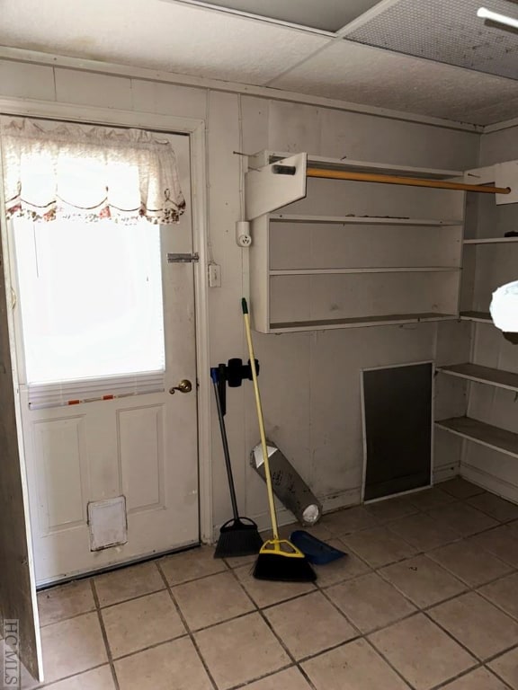 doorway with light tile patterned floors