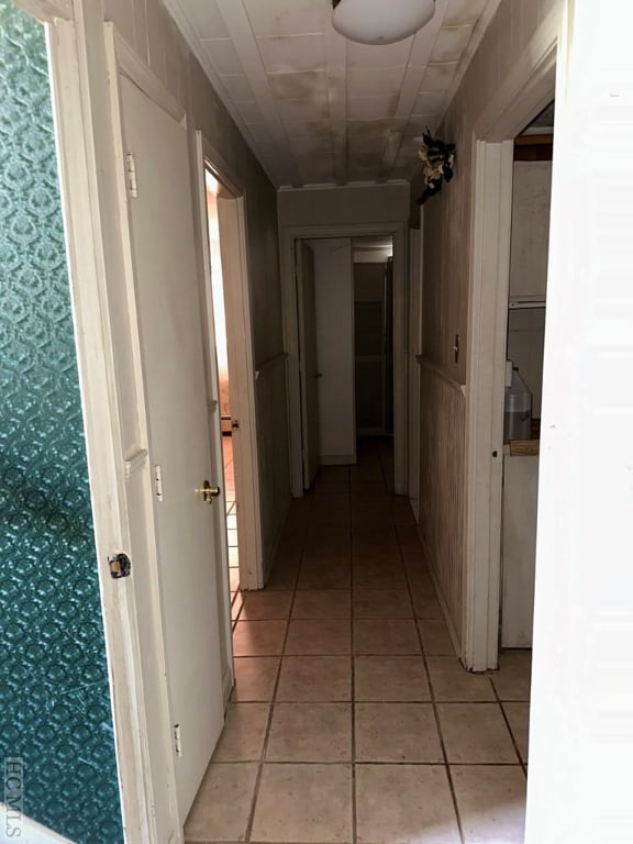 hall featuring light tile patterned floors