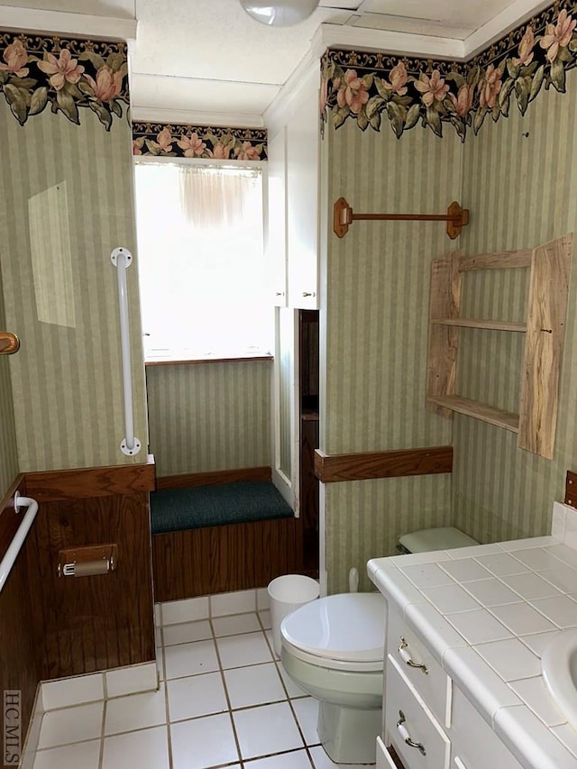 bathroom featuring crown molding, vanity, toilet, and tile patterned flooring