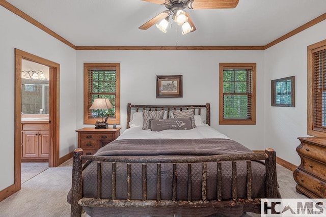 bedroom with light colored carpet, baseboards, ornamental molding, ensuite bath, and ceiling fan