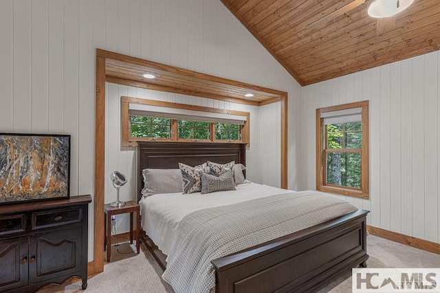 bedroom featuring light colored carpet, lofted ceiling, wood walls, baseboards, and wooden ceiling