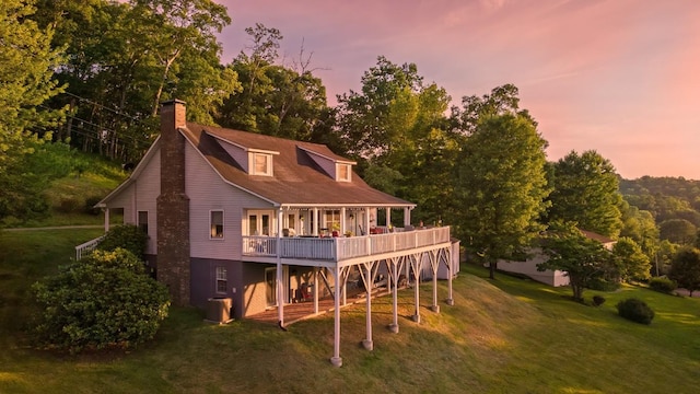 150 Lauren Ln, Franklin, NC 28734 - back of house at dusk with a lawn, a wooden deck, a chimney, and stairs