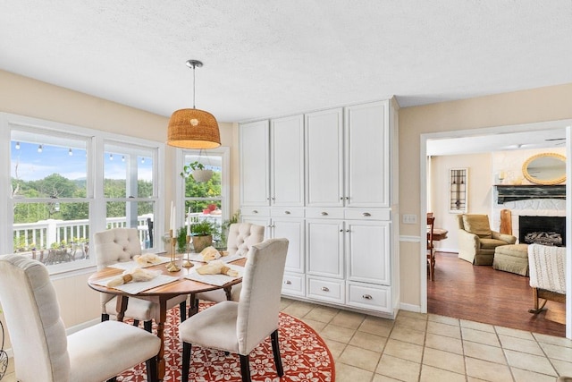150 Lauren Ln, Franklin, NC 28734 - dining room with light tile patterned floors, healthy amount of natural light, and a fireplace