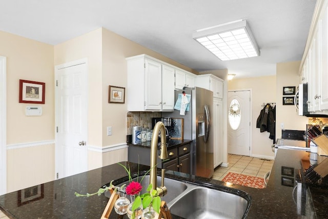150 Lauren Ln, Franklin, NC 28734 - kitchen featuring range, white cabinets, light tile patterned flooring, stainless steel fridge, and dark stone counters