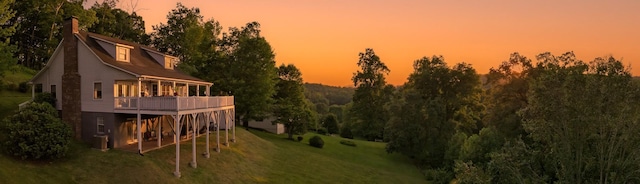 150 Lauren Ln, Franklin, NC 28734 - rear view of house featuring a lawn, a chimney, and a deck