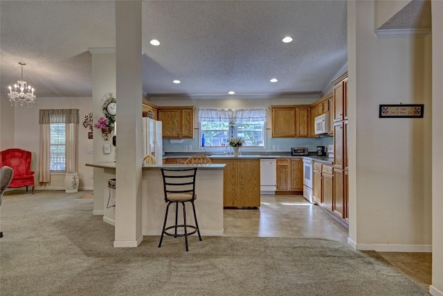 264 Cole Mountain Cir, Highlands, NC 28741 - kitchen featuring white appliances, a textured ceiling, a peninsula, a chandelier, and crown molding