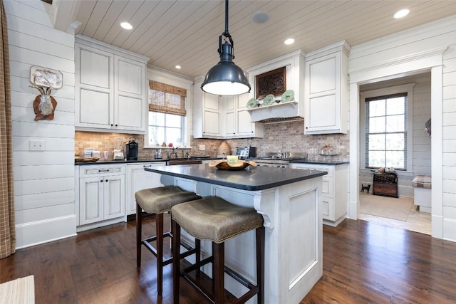 kitchen with dishwasher, dark countertops, tasteful backsplash, and wooden ceiling