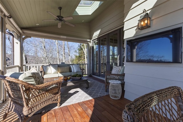 wooden terrace with an outdoor living space, french doors, and ceiling fan