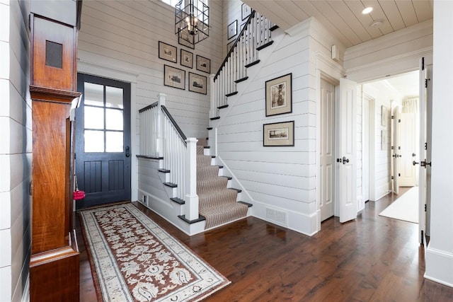 entryway featuring wood finished floors, visible vents, recessed lighting, stairs, and crown molding