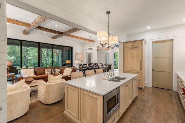 842 N High Mountain Dr, Cashiers, NC 28717 - kitchen with open floor plan, a sink, stainless steel microwave, dark wood-type flooring, and light countertops