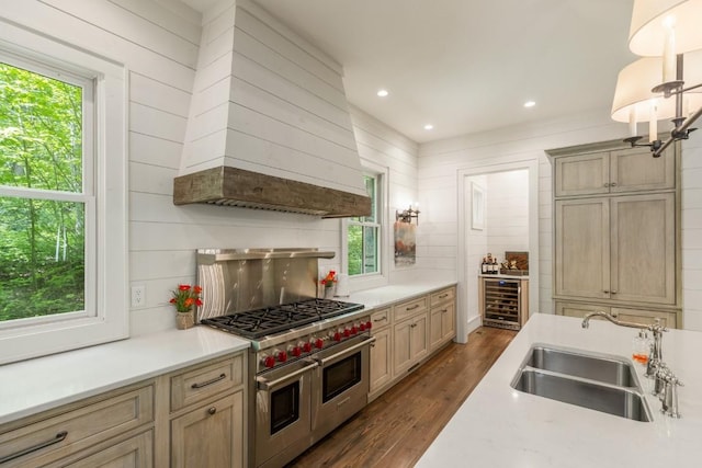 842 N High Mountain Dr, Cashiers, NC 28717 - kitchen with double oven range, beverage cooler, a sink, wall chimney exhaust hood, and healthy amount of natural light