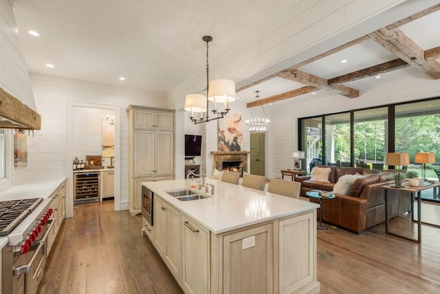 842 N High Mountain Dr, Cashiers, NC 28717 - kitchen featuring beverage cooler, a sink, hardwood / wood-style floors, cream cabinets, and beamed ceiling
