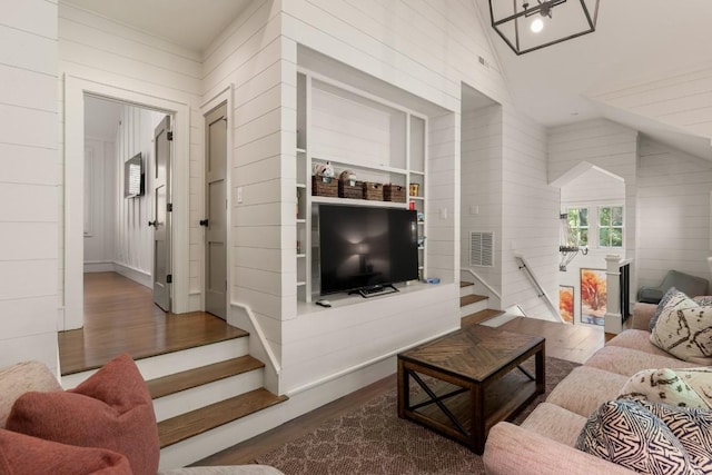 842 N High Mountain Dr, Cashiers, NC 28717 - living room featuring wood finished floors, lofted ceiling, wood walls, and stairway