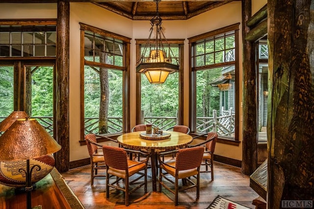 sunroom featuring beamed ceiling and wood ceiling