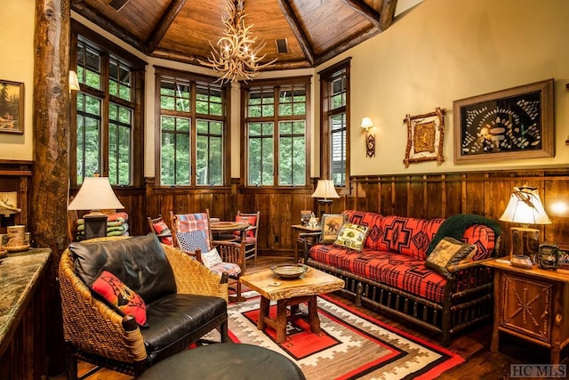 sitting room featuring vaulted ceiling with beams, hardwood / wood-style floors, wooden ceiling, and wood walls