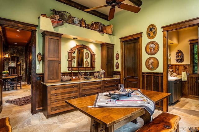 bathroom featuring vanity, beam ceiling, wooden walls, and ceiling fan