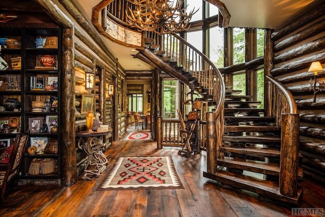 wine room featuring dark hardwood / wood-style flooring, rustic walls, and a notable chandelier