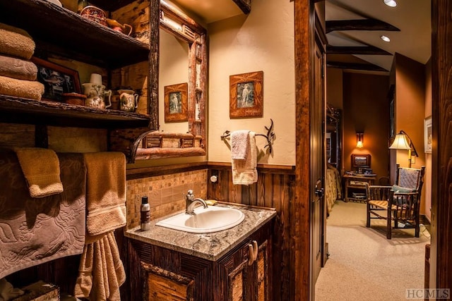 bathroom featuring vanity and decorative backsplash