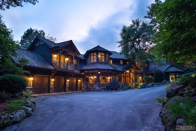 view of front of home with a garage and a balcony