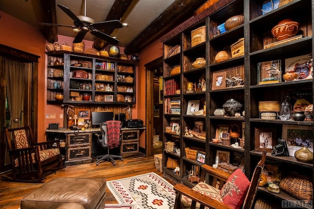 office space with wood-type flooring, built in desk, and ceiling fan