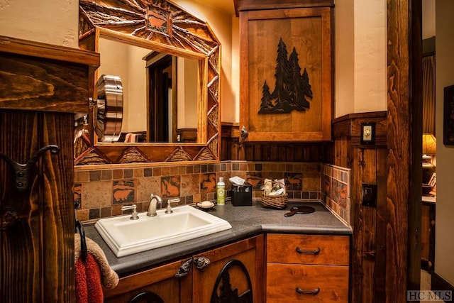 bathroom with tasteful backsplash and vanity