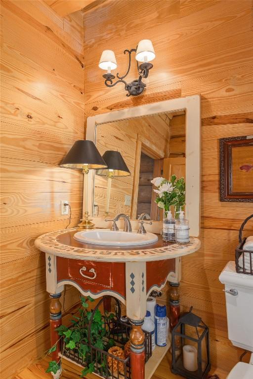 865 Toxaway Dr, Lake Toxaway, NC 28747 - bathroom featuring toilet, wooden walls, and vanity