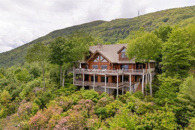 865 Toxaway Dr, Lake Toxaway, NC 28747 - rear view of property with log siding, a chimney, a wooded view, and a mountain view