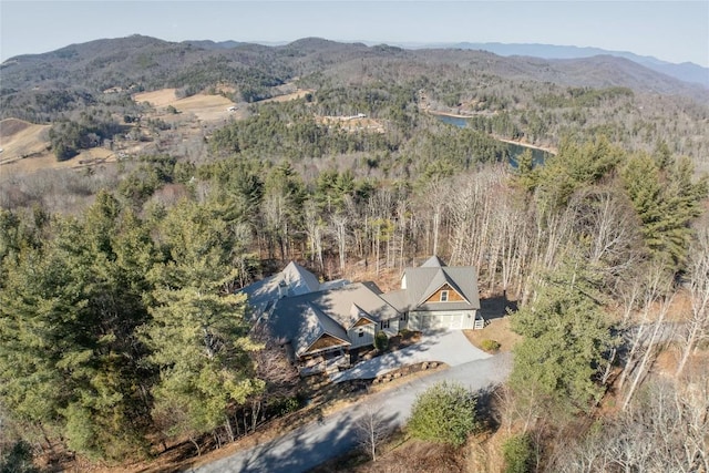 drone / aerial view with a wooded view and a mountain view