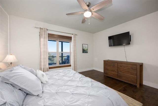 bedroom with ceiling fan, baseboards, and wood finished floors