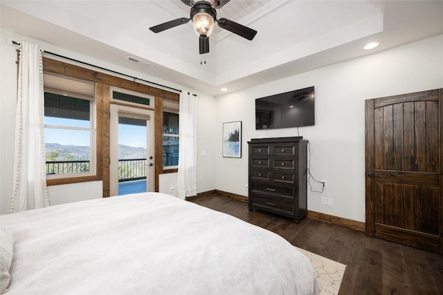 bedroom with dark wood finished floors, visible vents, baseboards, access to outside, and a raised ceiling