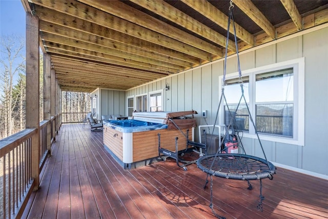 wooden deck featuring a hot tub