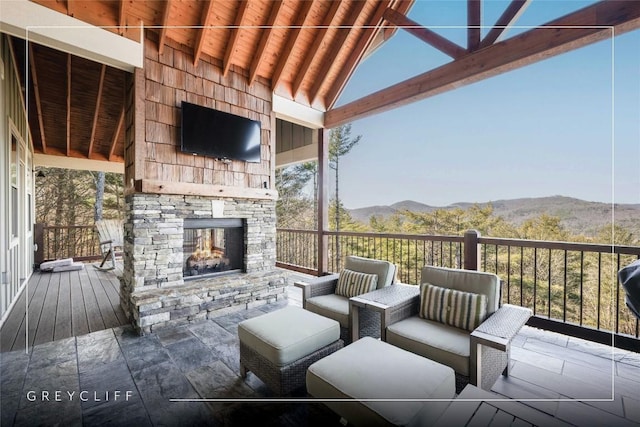 view of patio with an outdoor living space with a fireplace