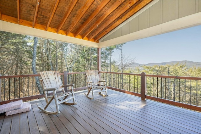 deck featuring a forest view and a mountain view