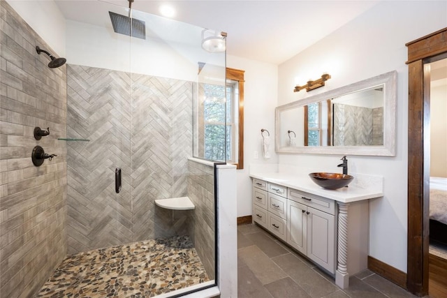 bathroom featuring visible vents, vanity, baseboards, tile patterned floors, and a stall shower