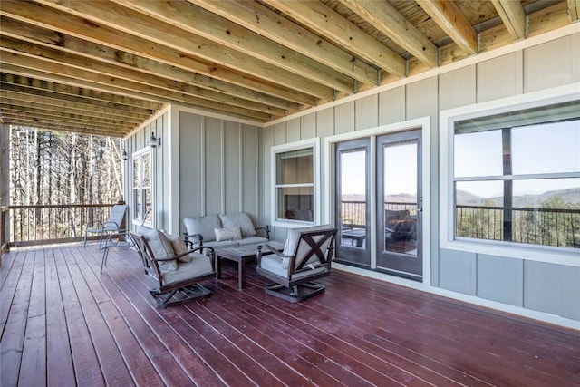 wooden terrace with an outdoor living space