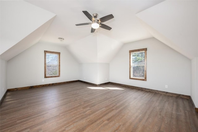 bonus room featuring lofted ceiling, baseboards, and wood finished floors