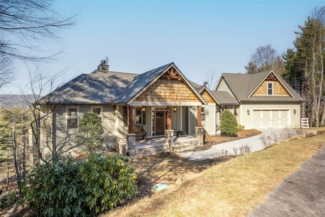 craftsman house with an attached garage, a porch, and board and batten siding