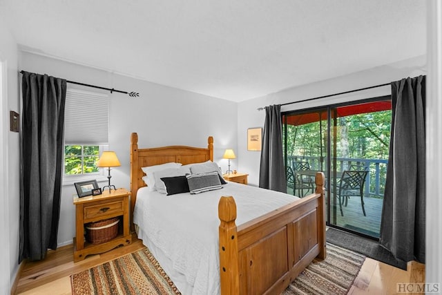 bedroom with light hardwood / wood-style flooring and access to outside