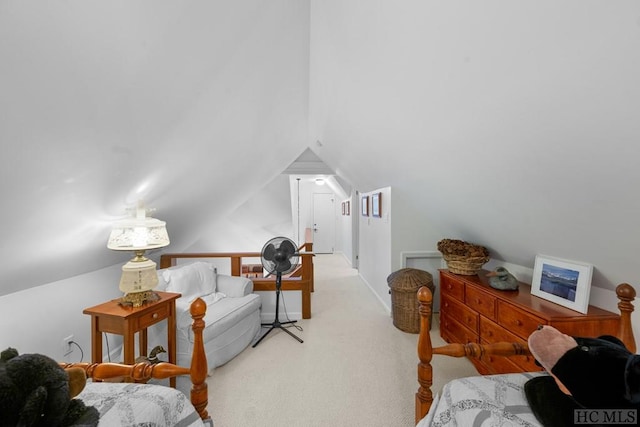 carpeted bedroom with lofted ceiling