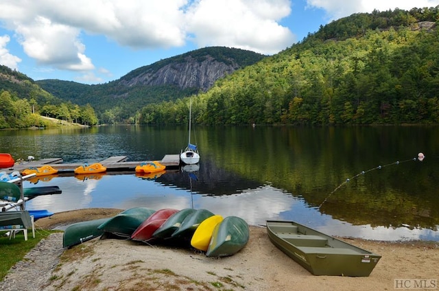 view of dock with a water and mountain view