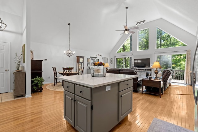 200 Blackberry Trl, Sapphire, NC 28774 - kitchen with gray cabinets, a center island, high vaulted ceiling, ceiling fan, and light wood-style floors